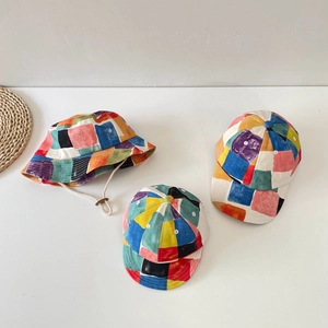 Macro view showing the colorful patchwork canvas material and stitching on kids hats