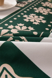 Macro view of green snowflake festive print on high-quality thick polyester tablecloth fabric