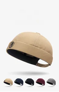 Dettaglio dei cappelli miki in kaki, blu navy e bordeaux con ricamo circolare