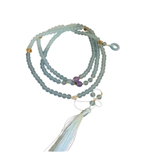 Pale blue multi-layer glass bead necklace with purple accents and long silk tassels