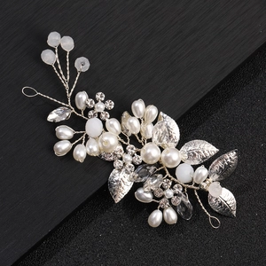 Detail of silver bridal hair vine with white pearls, crystals and metallic leaves