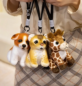 Three plush animal keychains attached to a waistline showcasing size and texture