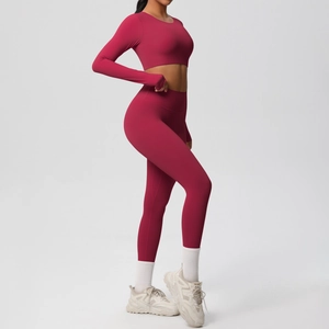 Detail of burgundy yoga set featuring thumb holes on sleeves and high waist fitness leggings