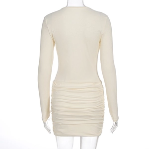 Rear view of long sleeve beige mini dress featuring sophisticated pleated ruching details