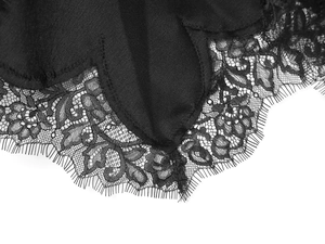 Detailed close-up of intricate black floral lace with delicate eyelash trim edges