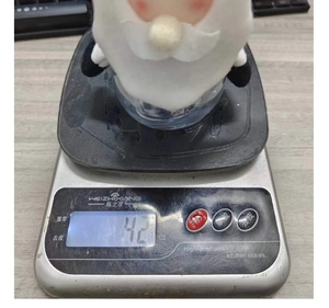 Detail showing the exact weight of Christmas candy jar on an electronic digital scale