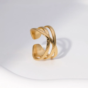 Detail of a minimalist gold layered cross open ring in high-polished stainless steel