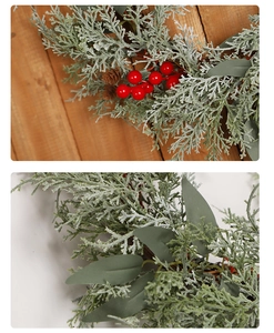 Close-up of frosted cedar needles with red berries and pine cones for Christmas decor