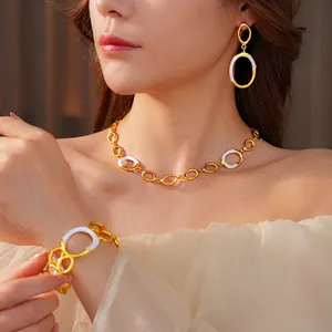 Golden necklace, bracelet and earrings set with white enamel oval link design