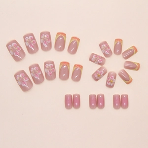 Détail des accents floraux 3D et du dégradé français sur les faux ongles amovibles