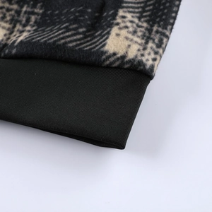 Detail of ribbed cuffs and thick plaid fleece lining on men's winter hooded jacket