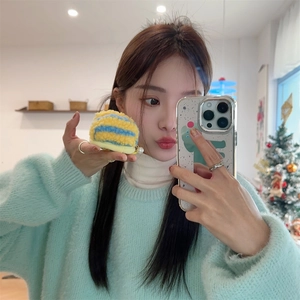 Detail of colorful striped plush case and cute dinosaur phone shell in a cozy scene