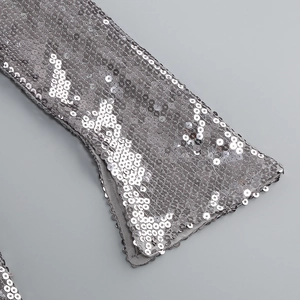 Gros plan de sequins argentés sur tissu à lacets pour une robe de soirée étincelante
