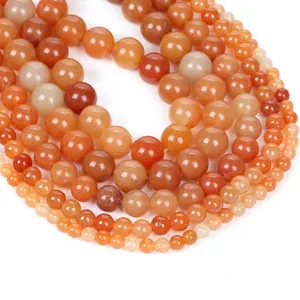 Polished natural carnelian agate round beads in vibrant orange and red shades for jewelry