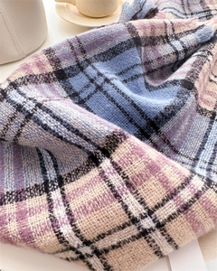 Detail of soft multi-color plaid cashmere-like scarf with textured woven fabric