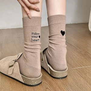 Detail of khaki crew sock with Follow Your Heart embroidery and black heart pattern