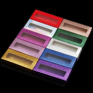 Close-up of assorted glitter eyelash packaging boxes with clear windows in various colors
