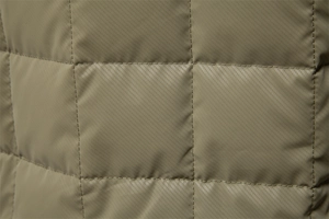 Detailed close-up of square quilted texture on olive green men's stand collar jacket
