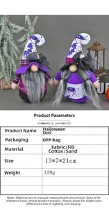 Detail of Halloween gnome dolls with bat and spider patterns on purple and black fabric