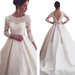 Elegant white lace long sleeve wedding dress with pink ribbon and open back view