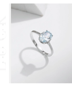 Detail of S925 silver ring with oval light blue gemstone and shimmering pavé setting