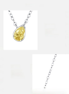 Close-up of S925 sterling silver chain with a pear-cut yellow zircon drop pendant