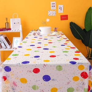 White disposable plastic tablecloth with colorful balloons for birthday party decor