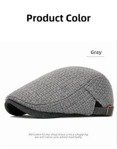 Close-up of gray knitted beret with textured weave and adjustable metal side buckle detail