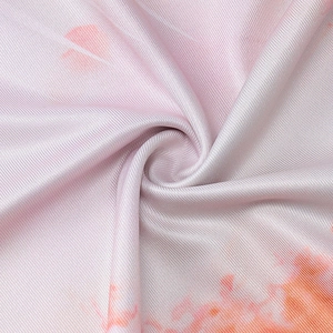 Detailed close-up of pink and white gradient floral printed twill fabric texture