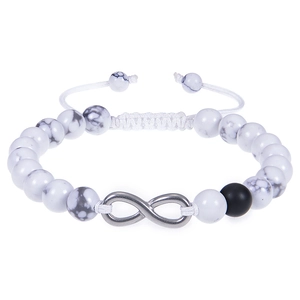 Macro detail of white turquoise beads and infinity charm on a hand-woven bracelet