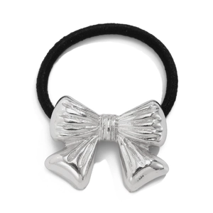 Detail of a silver metal bow hair tie with textured finish on a black elastic band