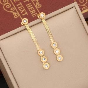 Golden herringbone chain earrings with round zircon charms and Roman numerals in a box