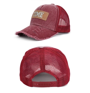 Detail of red vintage washed trucker hat with 1966 patch and breathable mesh back