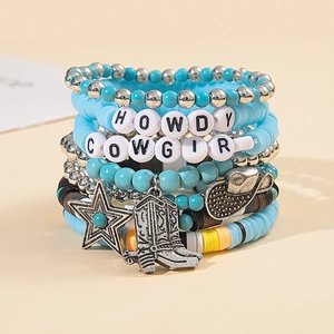 Detail of bohemian layered bracelets with turquoise heishi beads and silver western charms