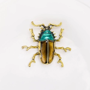 Vintage style gold alloy beetle brooch with green enamel and metallic finish for women