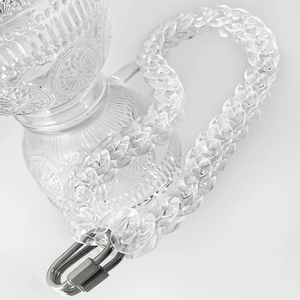 Macro shot of transparent acrylic chain links with a premium metal clasp on white background