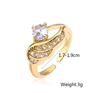 Detail view of gold-plated wing ring with zircon stones, showing size and 3g weight