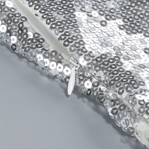 Detail view of silver sequin evening dress showing invisible zipper and sequin density