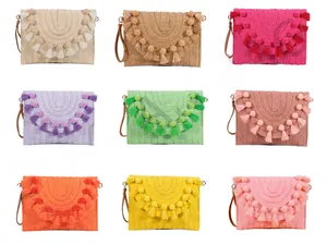 Detail view showing nine colorful straw clutch bags with pom-pom and tassel decorations