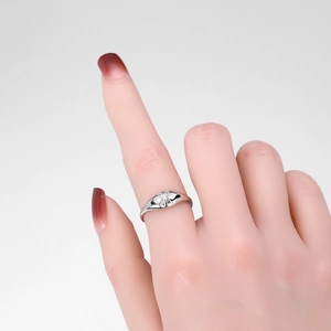 Close-up of S925 sterling silver ring with small diamond floral detail on finger