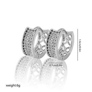 Detail view of silver hoop earrings with zircon pavé and geometric hollow pattern