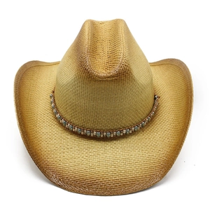 Detail of western straw cowboy hat featuring colorful bead band and distressed brim finish