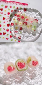 Detail of 3D embossed strawberry and daisy nail stickers with translucent matte texture