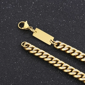 Detailed close-up of golden Cuban link necklace with a square pendant and lobster clasp