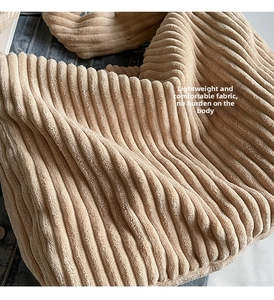Detailed macro view of beige corduroy fabric texture and soft ribbed material of the tote bag