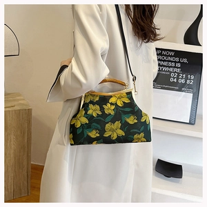 Green cheongsam handbag with yellow floral embroidery and natural wooden handle