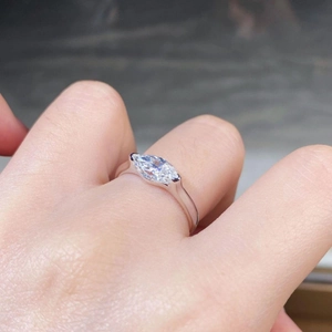 Macro shot of 925 silver ring featuring a 1 carat marquise-cut moissanite on a finger