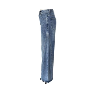 Side view detail of blue high-waisted wide-leg jeans with unique V-shaped panel stitching