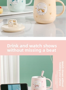 Detail of ceramic cat mug with spoon and phone holder lid in pastel colors