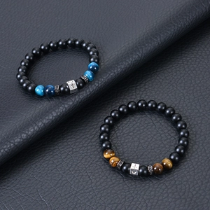 8mm tiger eye and lava stone cross beaded bracelets on a black leather background